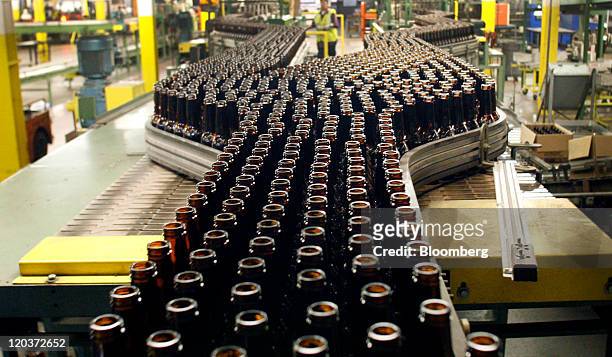 Shiner Beer bottles move down a conveyor belt at the Owens-Illinois Inc. Glass manufacturing plant in Waco, Texas, U.S., on Thursday, Aug. 4, 2011....