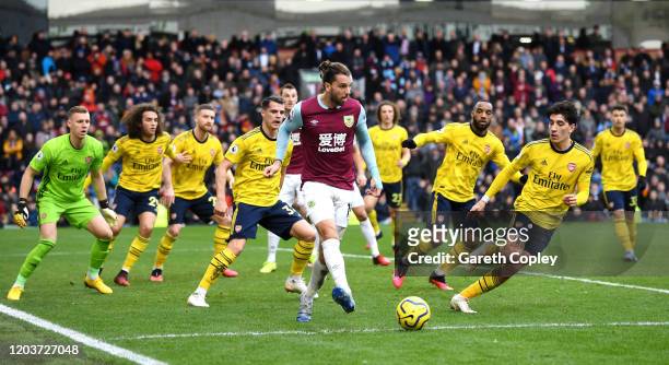 Jay Rodriguez of Burnley passes the ball as he is surrounded by Arsenal players during the Premier League match between Burnley FC and Arsenal FC at...