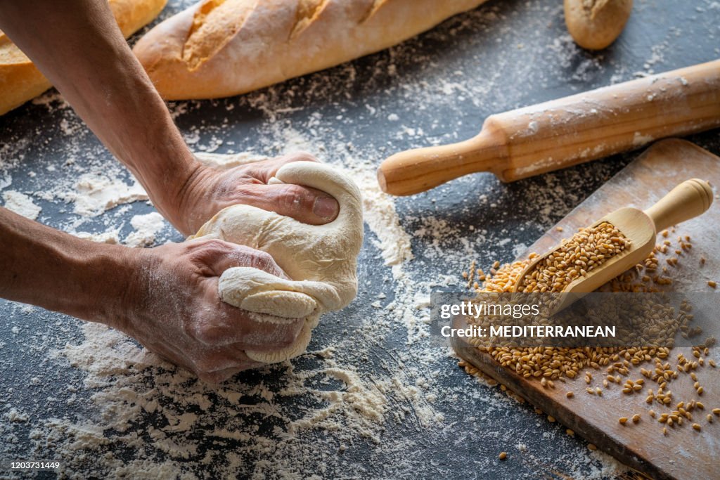 Baker man hands breadmaking kneading bread