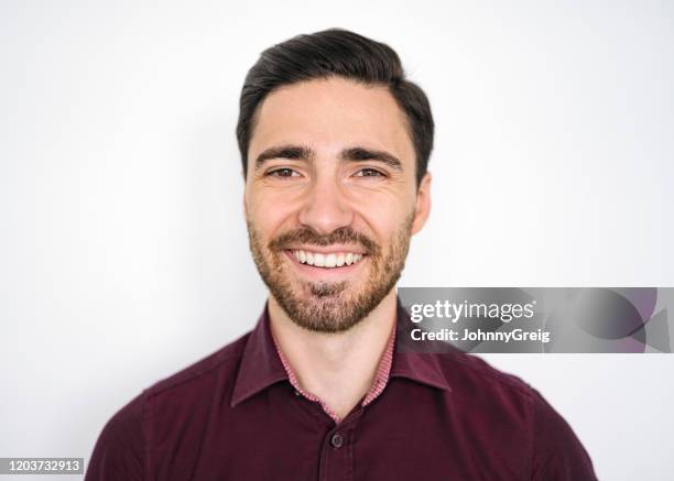 portrait of smiling caucasian male in late 20s - maroon stock pictures, royalty-free photos & images