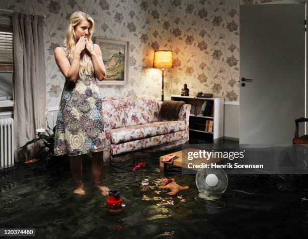 woman in flooded living room - ankle deep in water bildbanksfoton och bilder