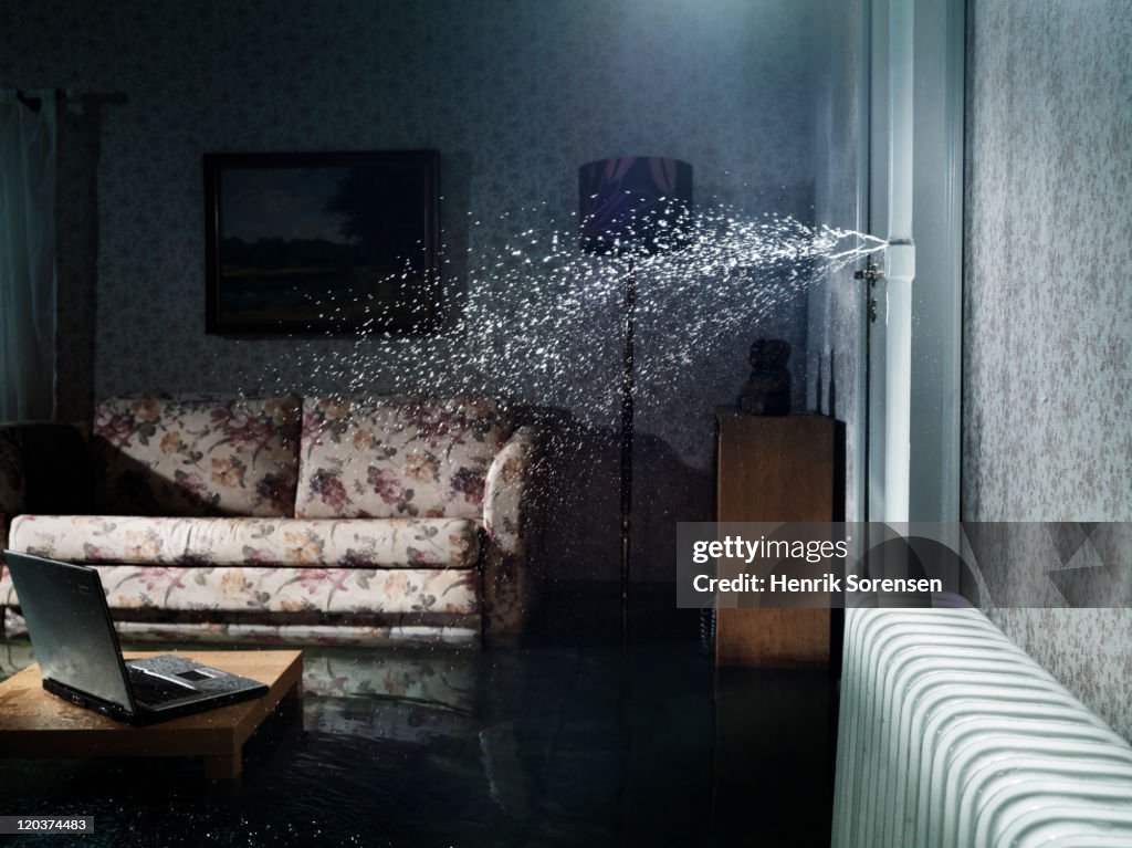 Broken water pipe in flooded room