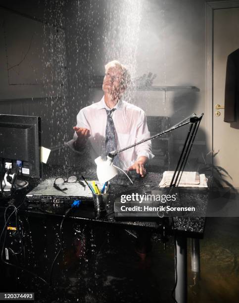 businessman in flooded office - emergency department stock pictures, royalty-free photos & images