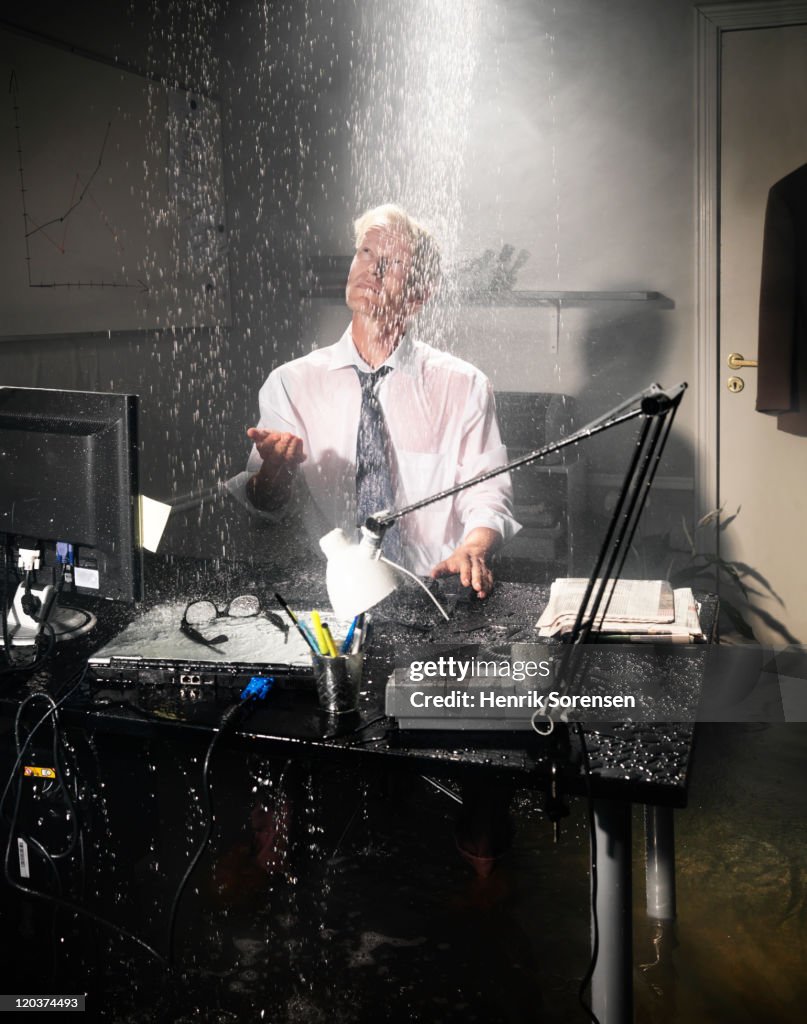 Businessman in flooded office