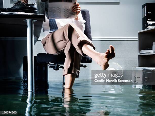 businessman in flooded office - business flood stock pictures, royalty-free photos & images