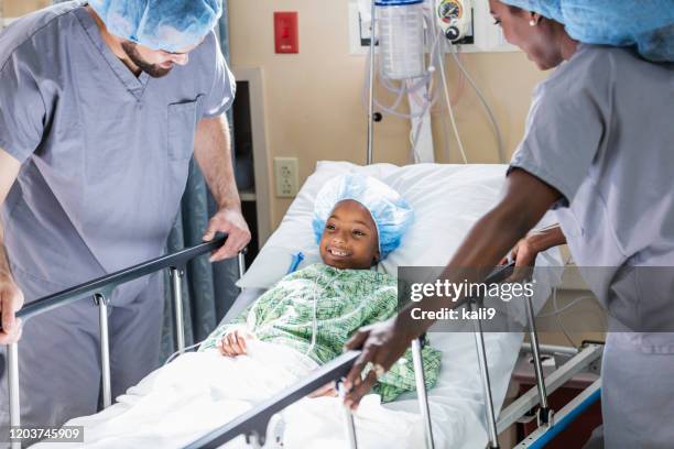 african-american girl in hospital with doctors - pediatric nurse stock pictures, royalty-free photos & images