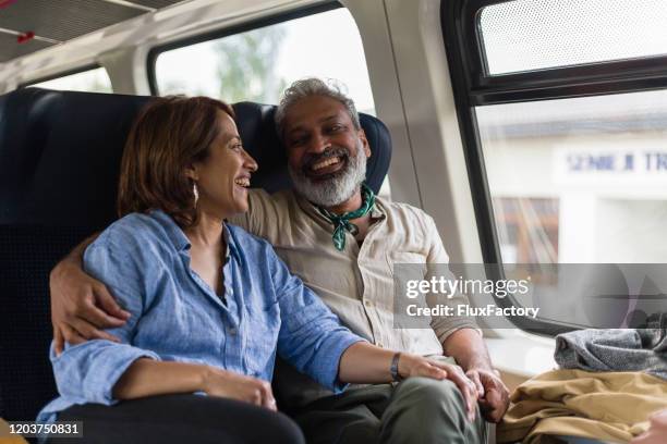 excited indian tourist couple can't wait for another adventure - train interior stock pictures, royalty-free photos & images