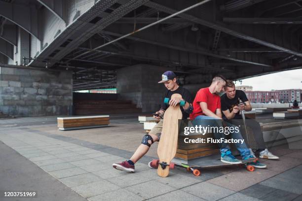 carefree skater using mobile phone - pro russian stock pictures, royalty-free photos & images