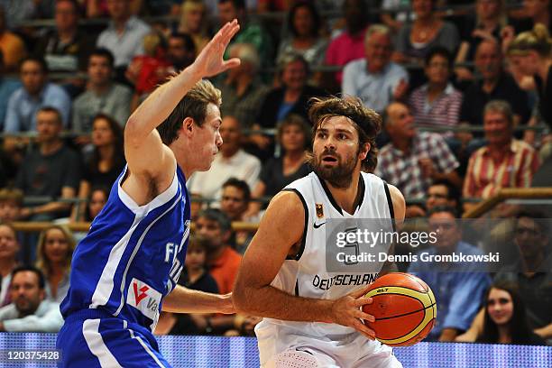 Petteri Koponen of Finland challenges Johannes Herber of Germany during the international basketball match between Germany and Finland at ENERVIE...