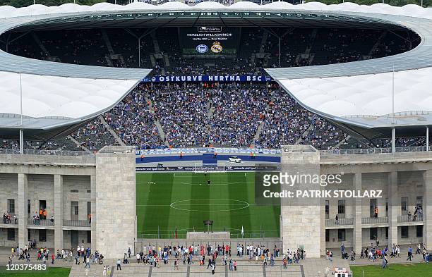 Exterior view of Berlin's Olympic stadium taken as supporters arrive to attend the friendly football match Hertha Berlin vs Real Madrid on July 27,...