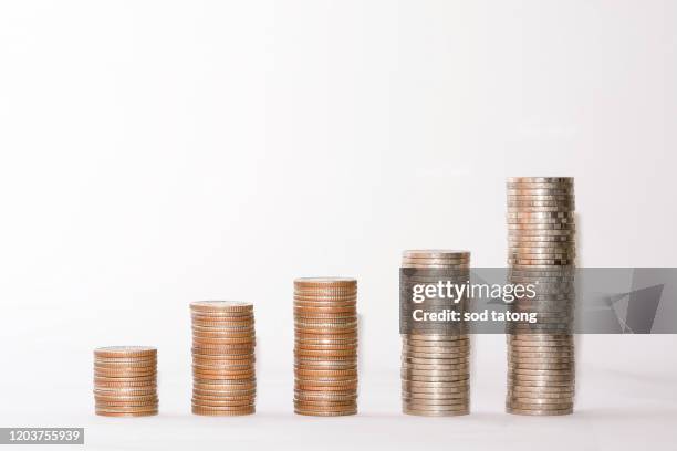 coins arranged on a white background - coin stack graph stock pictures, royalty-free photos & images