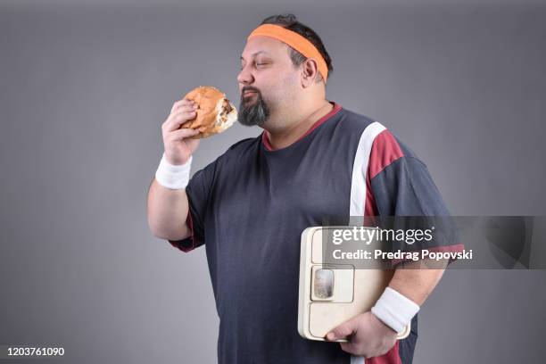 smelling delicious burger , fast food addict - chubby foto e immagini stock