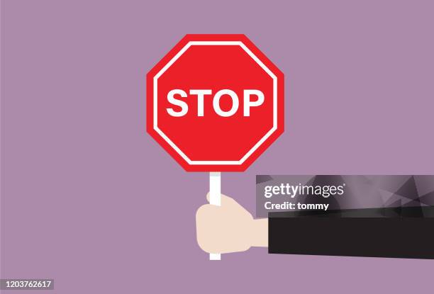 die menschliche hand hält ein stoppschild - stop gesture stock-grafiken, -clipart, -cartoons und -symbole