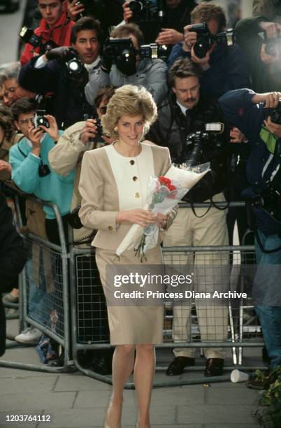 Diana, Princess of Wales arrives at Claridge's Hotel in London for a charity lunch, April 1989. She is wearing a suit by Catherine Walker.