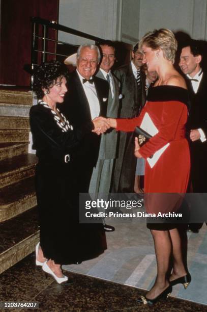 Diana, Princess of Wales meets actress Joan Collins at the Aldwych Theatre in London during a production of the play 'Private Lives' by Noel Coward,...