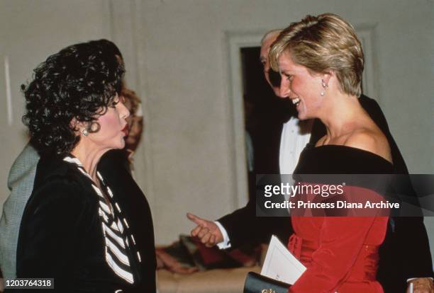 Diana, Princess of Wales meets actress Joan Collins at the Aldwych Theatre in London during a production of the play 'Private Lives' by Noel Coward,...