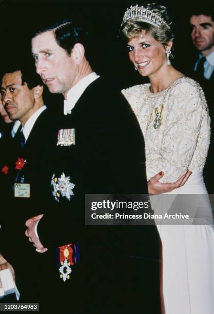 Prince Charles and Diana, Princess of Wales attend a banquet held by the Japanese Emperor in Tokyo, Japan, November 1990. Diana is wearing an evening...