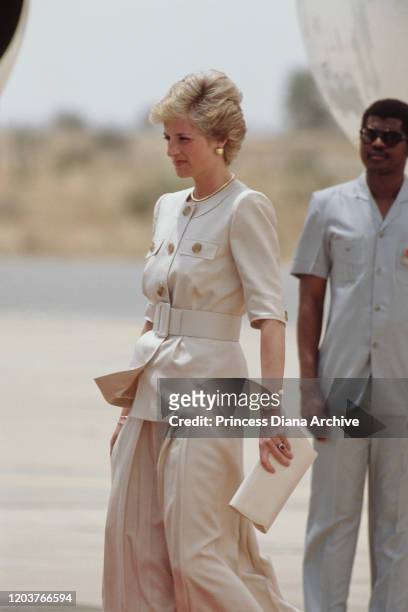 Diana, Princess of Wales arrives at Maiduguri airport in Nigeria, March 1990. She is wearing a suit by Catherine Walker.