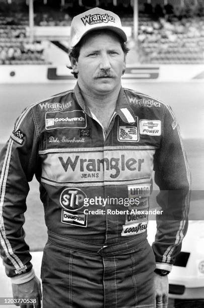Driver Dale Earnhardt Sr. Poses for photographers prior to the start of the 1986 Daytona 500 stock car race at Daytona International Speedway in...