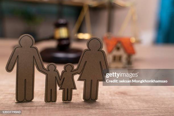 family figure and gavel on wooden table. family law concept - divorce lawyer stock pictures, royalty-free photos & images