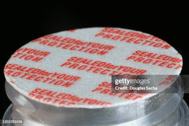 safety seal attached to a pill bottle to prevent tampering - freshness seal stock pictures, royalty-free photos & images