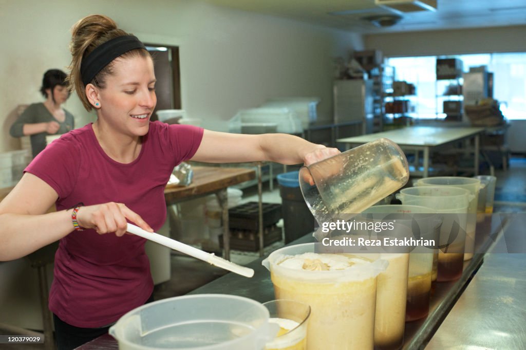 Woman pours oils into measuring containers