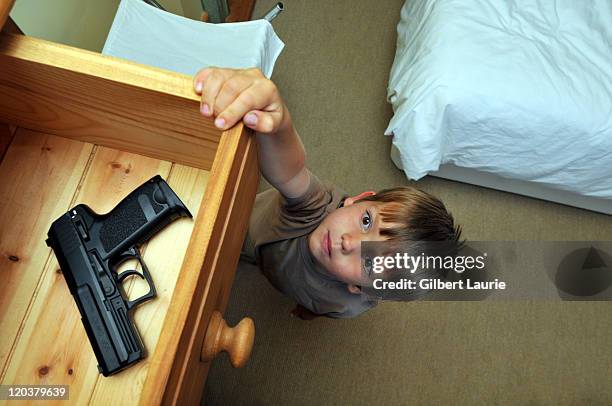 young child (4-6) reaching for a handgun - kid reaching stock pictures, royalty-free photos & images
