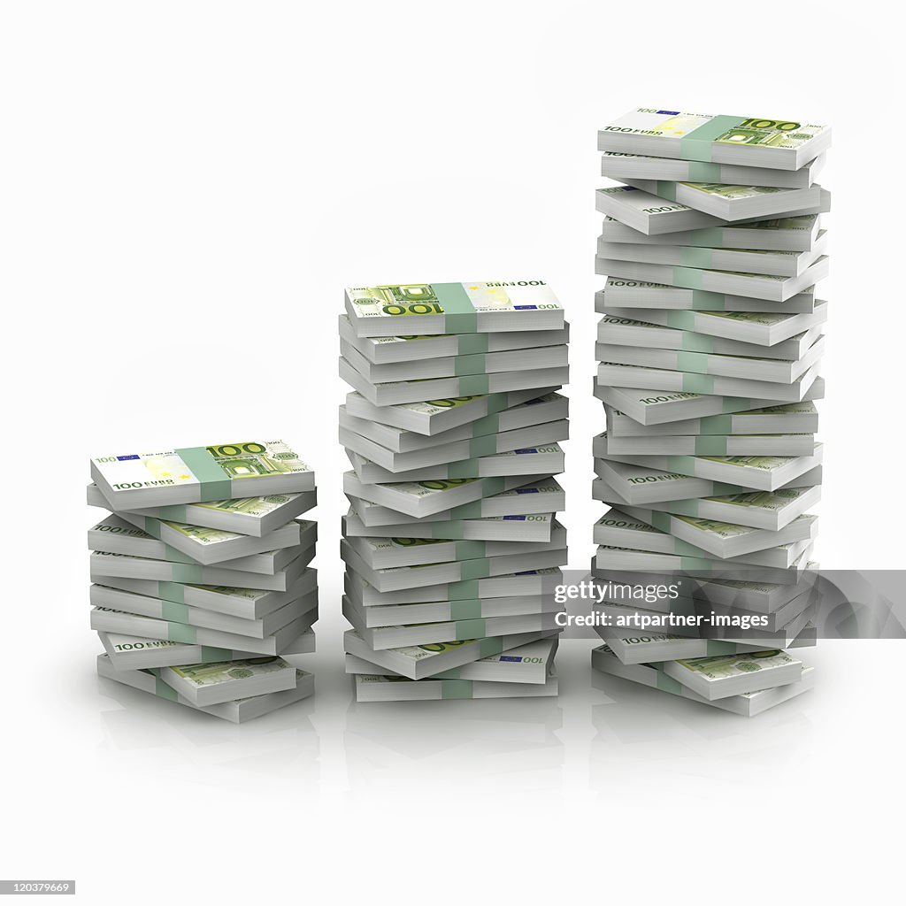 Stacked 100 euro bundles on white