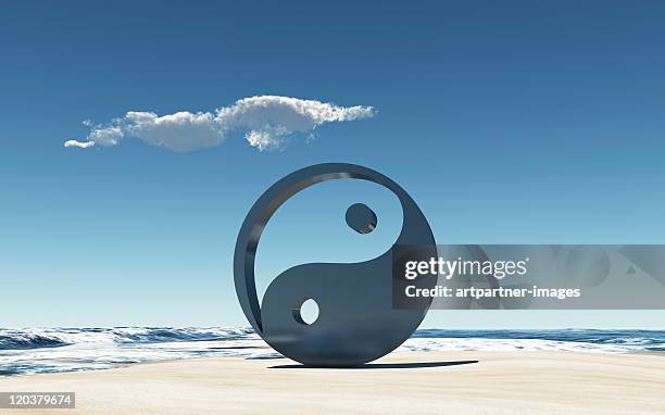 yin and yang symbol on a beach at the sea - yin och yang bildbanksfoton och bilder
