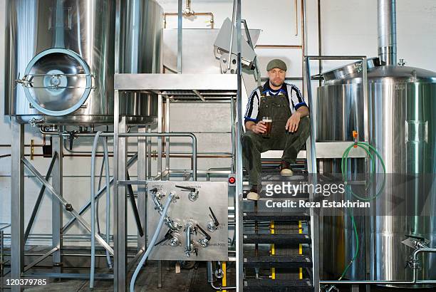 brewer enjoys a pint of ale - microbrewery stock pictures, royalty-free photos & images