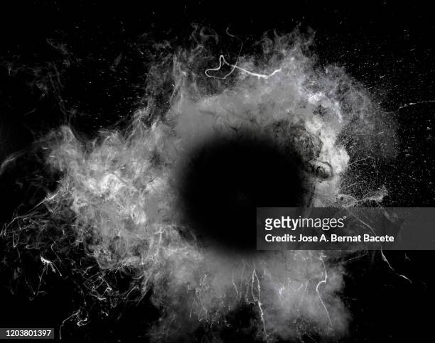 full frame of black hole in the middle of an explosion. - brandloch stock-fotos und bilder