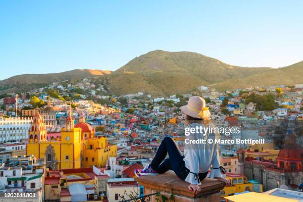 woman admiring guanajuato city and the basilica, guanajuato, mexico - guanajuato stock-fotos und bilder