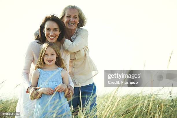 family portrait of three generations of women - generationsunterschied stock-fotos und bilder