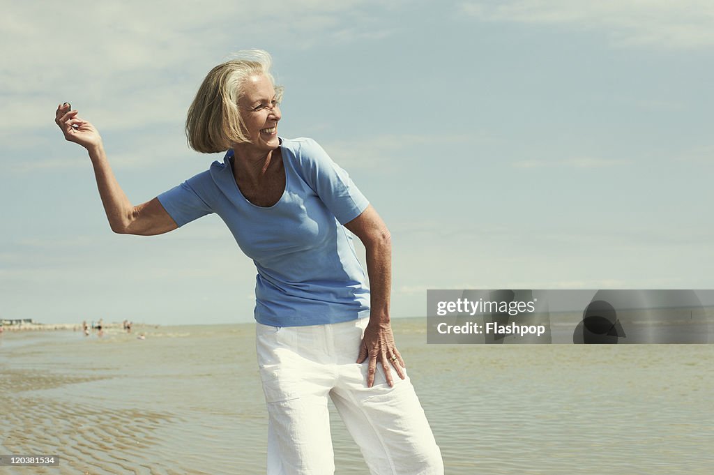 Senior woman having fun at the beach