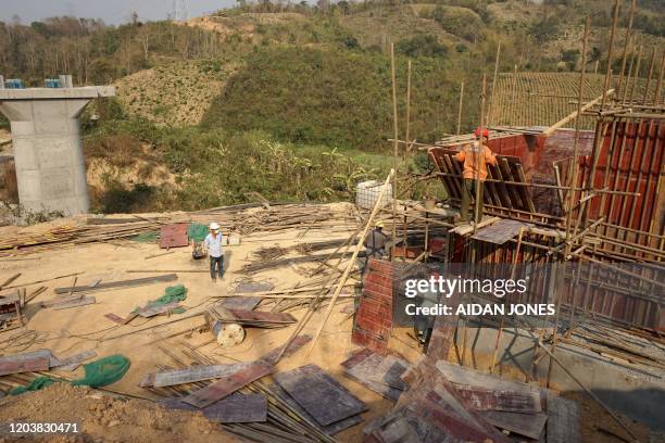 This picture taken on February 8, 2020 shows Chinese workers building the first rail line linking China to Laos, a key part of Beijing's 'Belt and...