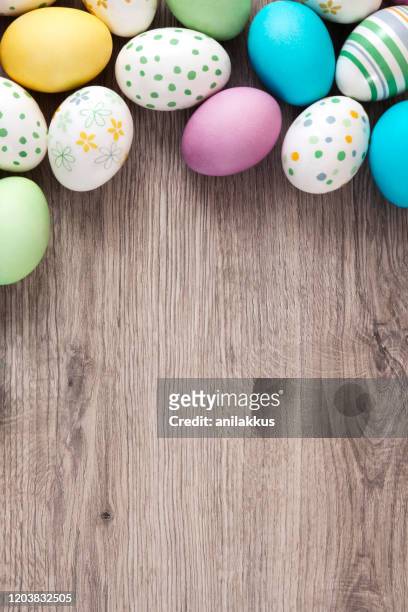 easter eggs on wooden background - easter stock pictures, royalty-free photos & images