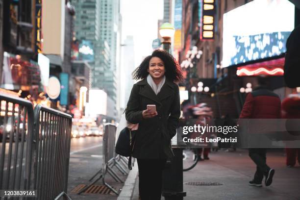 successful and elegant woman walks the streets of new york - businesswoman nyc stock pictures, royalty-free photos & images