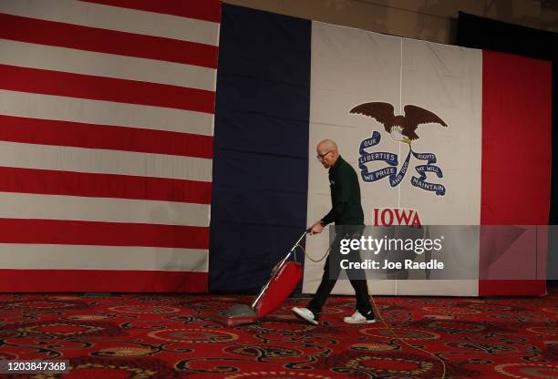 Joe Robinson vacuums the carpet before the start of the caucus night celebration party for Democratic presidential candidate Sen. Bernie Sanders at...