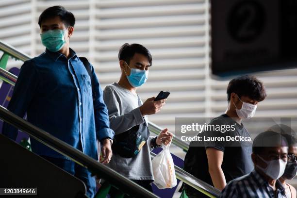 People wear surgical face masks on the Asoke BTS platform on February 28, 2020 in Bangkok, Thailand. Thai citizens and tourists have taken measures...