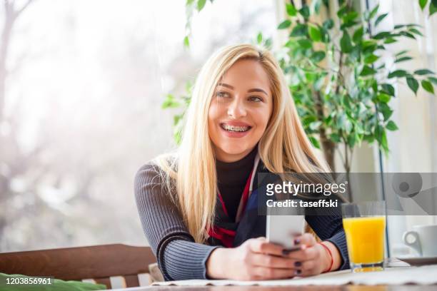 woman in cafe - braces stock pictures, royalty-free photos & images