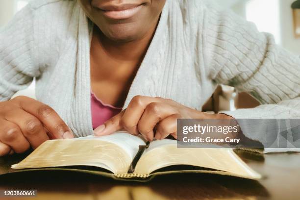 close-up of woman reading bible - new testament book stock pictures, royalty-free photos & images