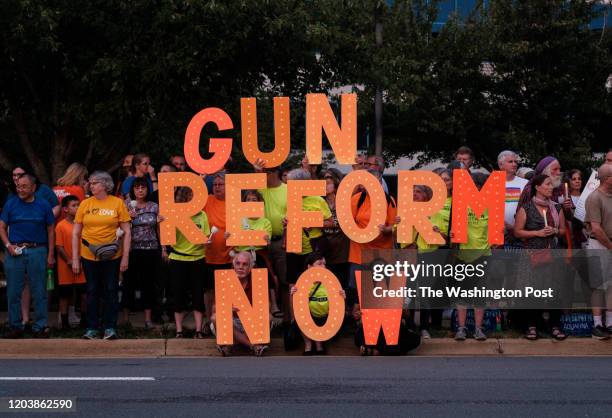 Gun control advocates take part of a candlelight vigil to honor of the victims of the mass shootings in El Paso, Texas and Dayton, Ohio, and Chicago,...