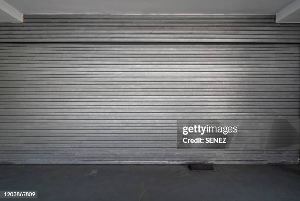 closed steel door / shop shutters - iron roll stockfoto's en -beelden