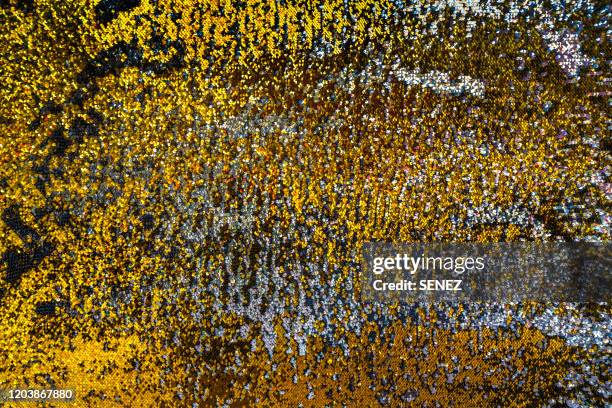 full frame shot of colourful vibrant glittering sequins - gold dress stockfoto's en -beelden