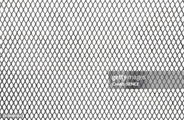 closeup wire fence aginst white background - ワイヤーメッシュ ストックフォトと画像