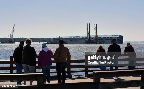 February 27, 2020 - St. Simons Island, Georgia, United States - People observe the Golden Ray cargo ship from the St. Simons Island Pier on February...