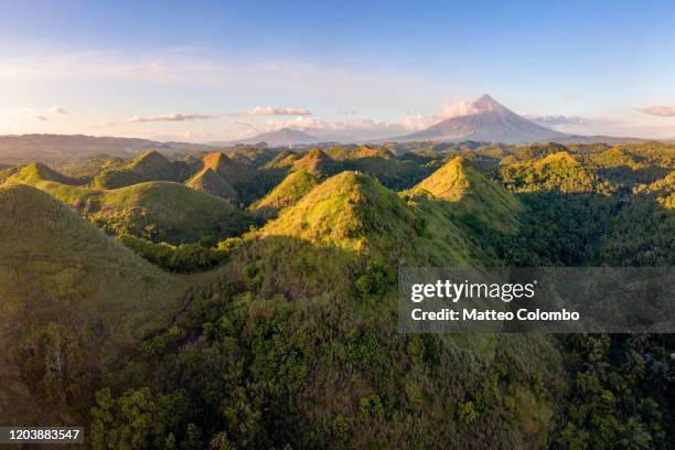 rolling hills and mt. mayon, albay, philippines - philippines volcano stock pictures, royalty-free photos & images