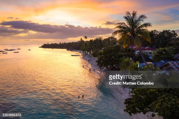 colorful sunset, alona beach, panglao, bohol, philippines - bohol philippines stock pictures, royalty-free photos & images