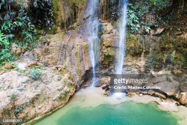 woman standing near waterfall, bohol, philippines - bohol philippines stock pictures, royalty-free photos & images