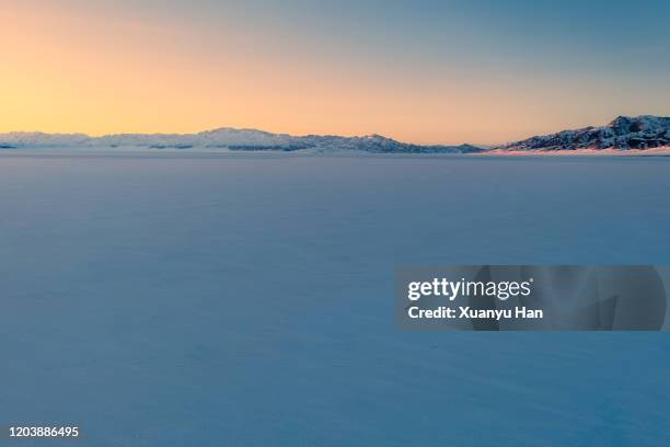 the natural landscape of frozen lake at dusk - snowfield stock pictures, royalty-free photos & images